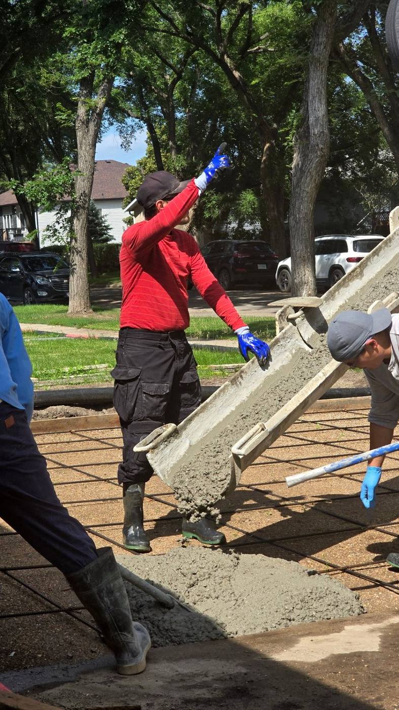 Owner Abbas guiding the chute during a decorative concrete pour